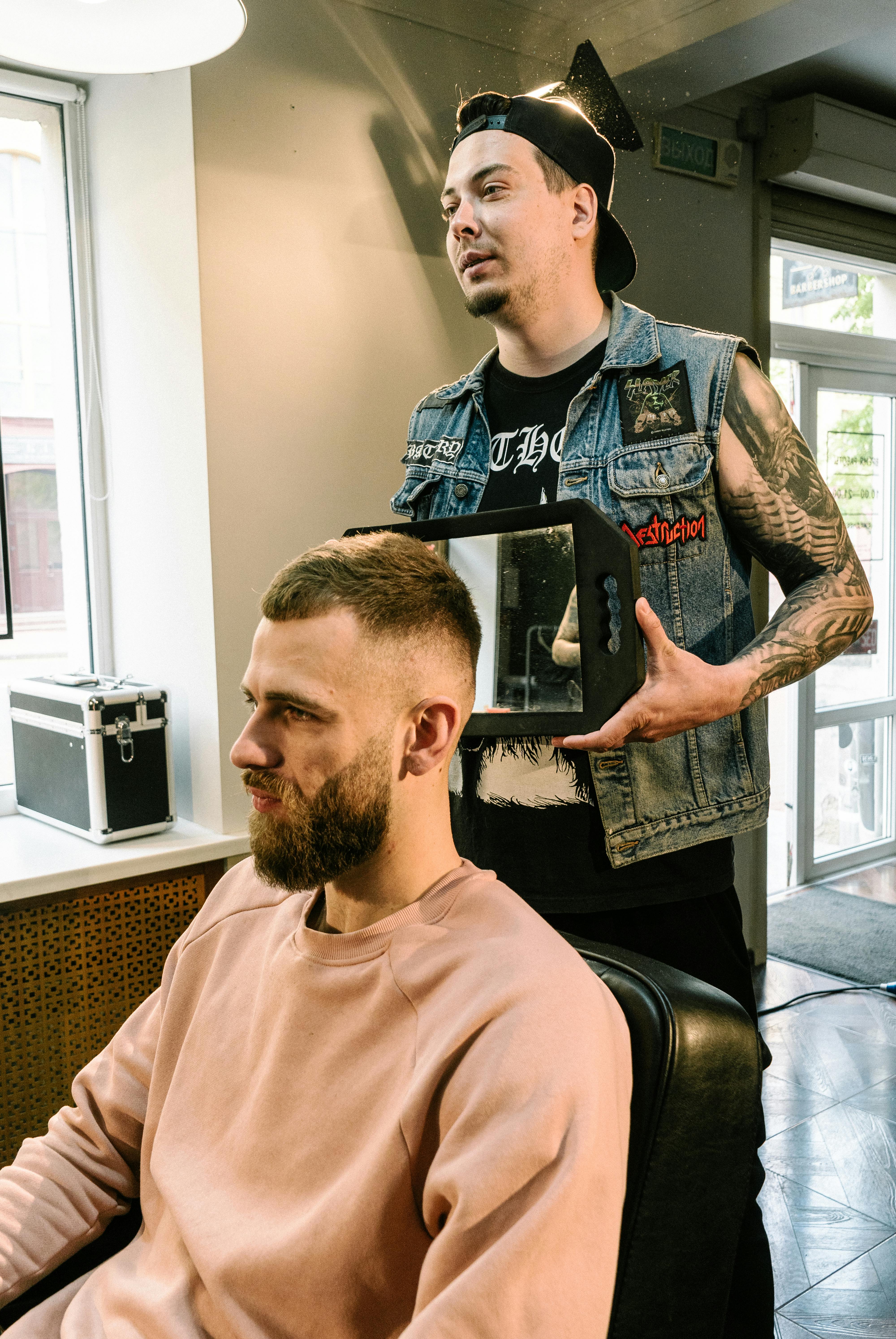 Barber showing client the finished cut