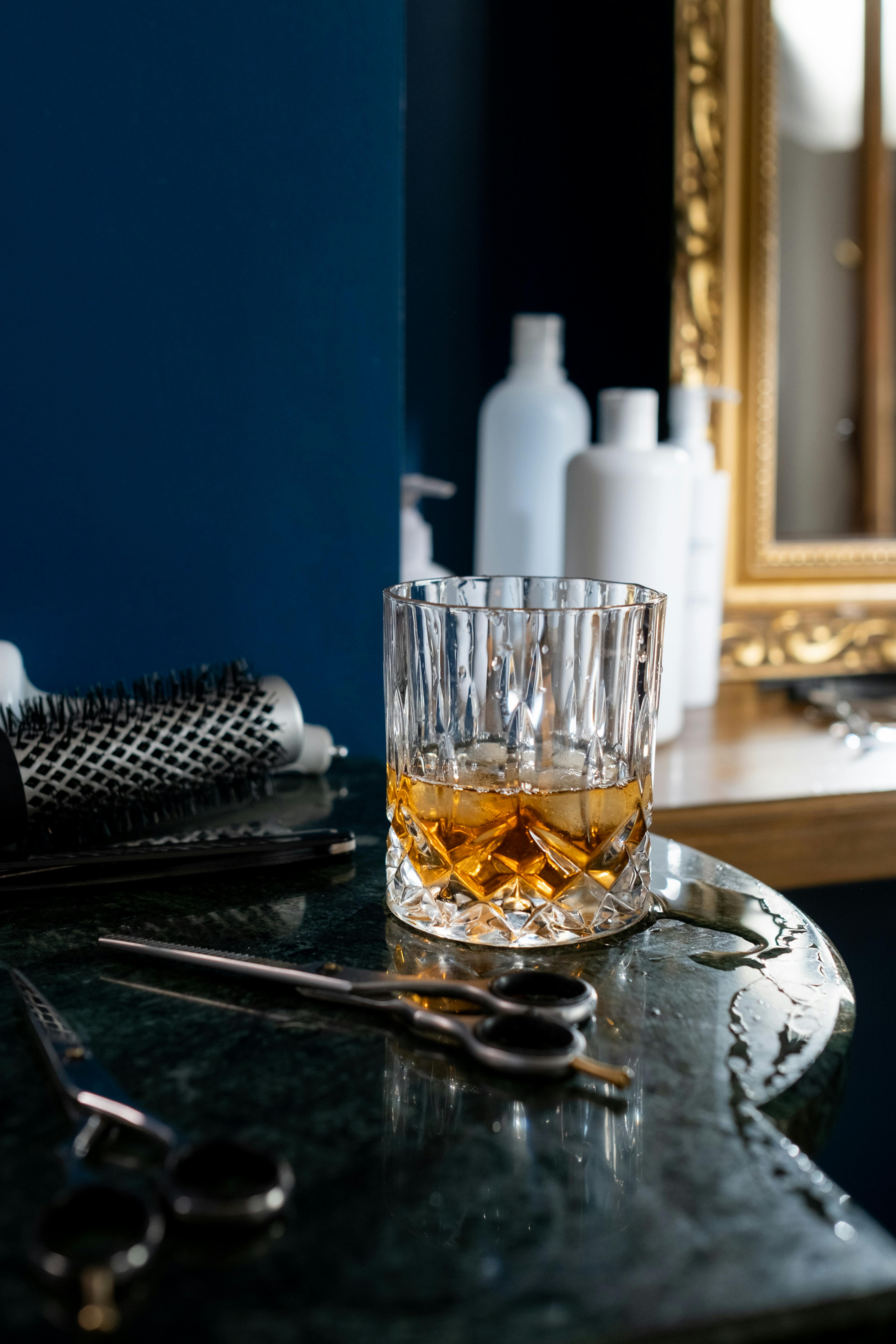 Barbershop detail — whiskey glass and scissors